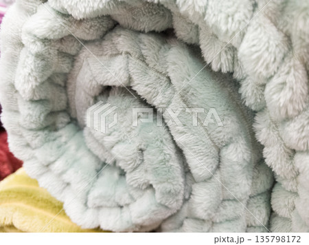 Cozy rolled blanket ready for warmth in a serene setting Cozy rolled blanket ready for warmth in a serene setting 135798172