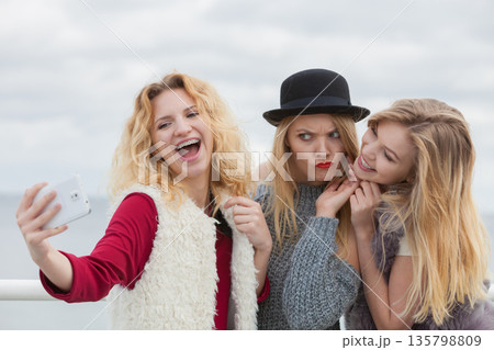 Three women taking selfie outdoor Three women taking selfie outdoor 135798809