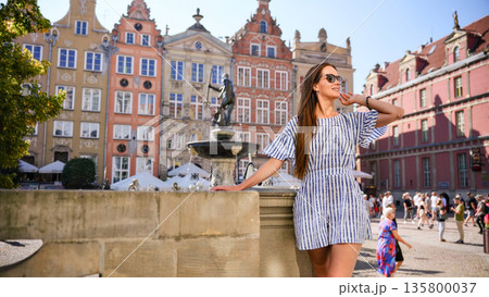 Tourist woman posing at Neptune Fountain in Gdansk Old Town Poland 135800037