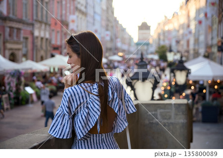 Young woman overlooking Old Town street market in Gdansk Poland 135800089