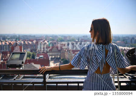 Woman enjoying panoramic view from observation deck in Gdansk old town Woman enjoying panoramic view from observation deck in Gdansk old town 135800094