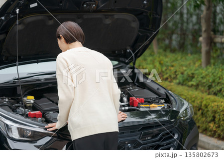 車が故障してボンネットを開ける女性 車が故障してボンネットを開ける女性 135802673
