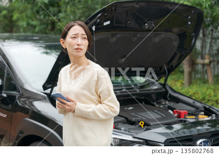 車が故障して電話で連絡をする女性 135802768