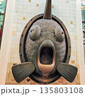 Fish sculpture with exaggerated features, mounted on a tiled wall in Amsterdam 135803108
