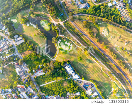 Aerial view drone shot of beautiful green golf field fairway and putting green Top down image for sport background and travel nature background Aerial view drone shot of beautiful green golf field fairway and putting green Top down image for sport background and travel nature background 135803316
