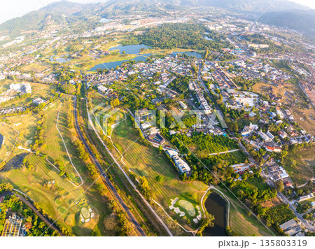 Aerial view drone shot of beautiful green golf field fairway and putting green Top down image for sport background and travel nature background Aerial view drone shot of beautiful green golf field fairway and putting green Top down image for sport background and travel nature background 135803319