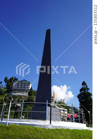 Scenic Batasia Loop war memorial with a towering black granite obelisk and Indian flag in Darjeeling 135803512