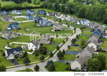 Low-density two story private homes in rural residential suburbs outside of Rochester, New York. Upscale suburban houses with large lot size and green grassy lawns in summer season 135804889