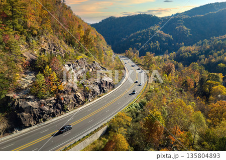 Wide multilane highway road in USA Appalachian mountains with fast driving cars. Above view of American transportation infrastructure 135804893