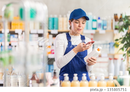 Young woman worker scanning qr code of cream 135805751