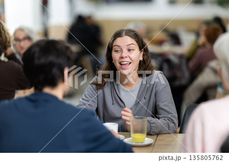 Large friendly family gathered at table to have meeting in restaurant Large friendly family gathered at table to have meeting in restaurant 135805762