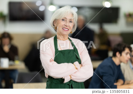 Elderly woman working as a barista in a coffee shop Elderly woman working as a barista in a coffee shop 135805831