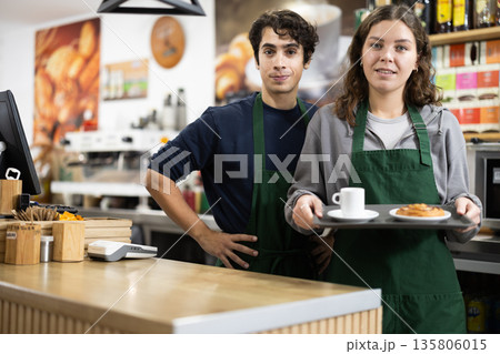 Portrait of two friendly cafe employees indoor Portrait of two friendly cafe employees indoor 135806015