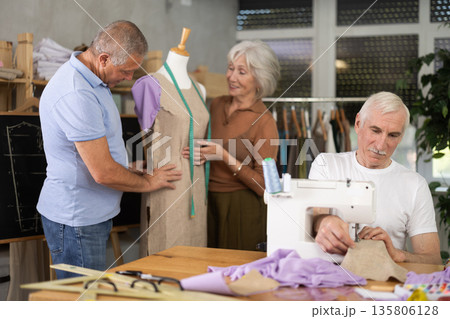 Elderly man and woman working with mannequin and sewing in class Elderly man and woman working with mannequin and sewing in class 135806128