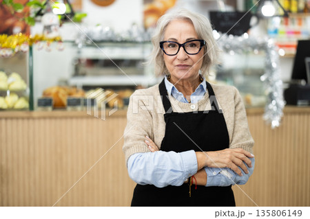 Friendly cafe employee invites you to visit establishment 135806149