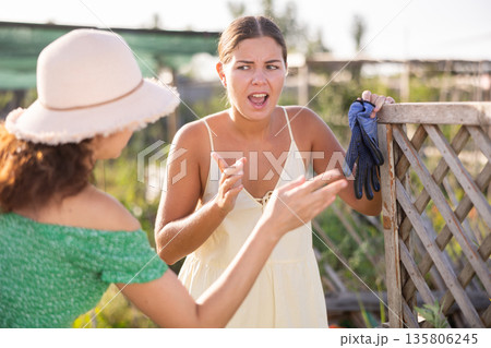 Adult and young woman quarreling in garden 135806245