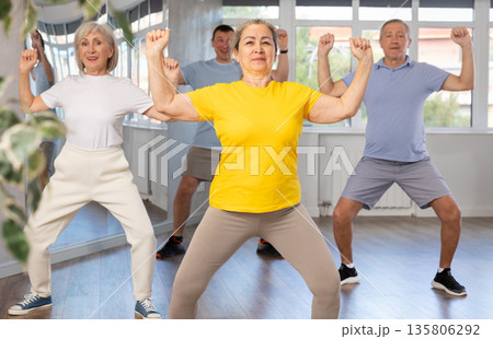 Elderly woman dances modern dances in group 135806292