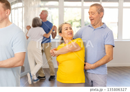 Couple of elderly man and woman dancing waltz Couple of elderly man and woman dancing waltz 135806327