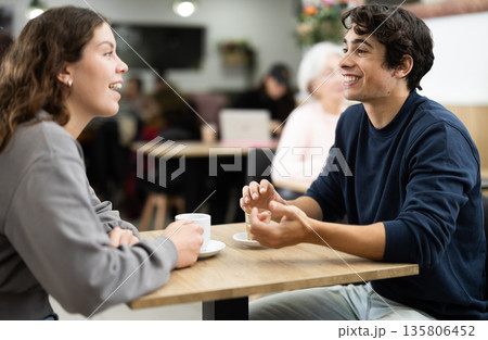 Girl in cafe sits near guy companion, work or romantic meeting dating Girl in cafe sits near guy companion, work or romantic meeting dating 135806452