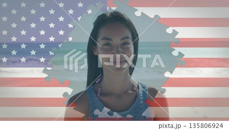 Standing woman wearing bikini straps at sandy beach with waves, featuring US flag jigsaw overlay Standing woman wearing bikini straps at sandy beach with waves, featuring US flag jigsaw overlay 135806924