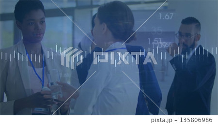 Networking professionals in suits exchanging ideas in conference lobby with lanyards smartphone Networking professionals in suits exchanging ideas in conference lobby with lanyards smartphone 135806986