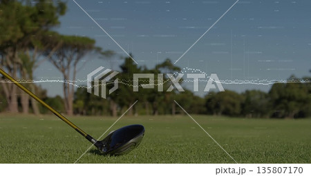 Showing golf driver head and shaft resting on fairway tee, with lush green turf, copy space 135807170