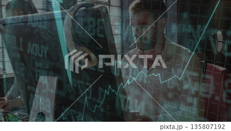 Analyzing senior professional viewing financial data overlays on dual screens at office, copy space 135807192