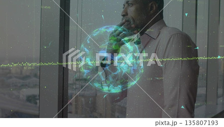 Businessman wearing pink shirt by office window surveying highways with 3D globe, copy space Businessman wearing pink shirt by office window surveying highways with 3D globe, copy space 135807193
