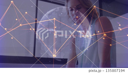 Leaning woman wearing sleeveless top focusing on computer screen at desk with tech network overlay Leaning woman wearing sleeveless top focusing on computer screen at desk with tech network overlay 135807194