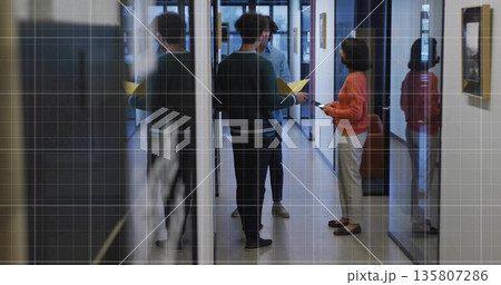 Talking three colleagues exchanging ideas in office corridor, with smartphone and yellow folder Talking three colleagues exchanging ideas in office corridor, with smartphone and yellow folder 135807286