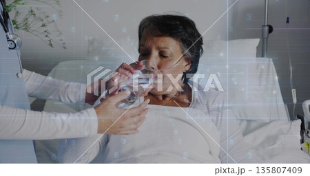 Leaning doctor assisting patient drinking water through nasal oxygen tube in hospital room Leaning doctor assisting patient drinking water through nasal oxygen tube in hospital room 135807409