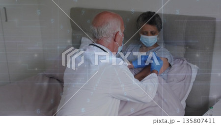 Administering physician wearing mask and gloves leaning over patient in bedroom, holding syringe Administering physician wearing mask and gloves leaning over patient in bedroom, holding syringe 135807411