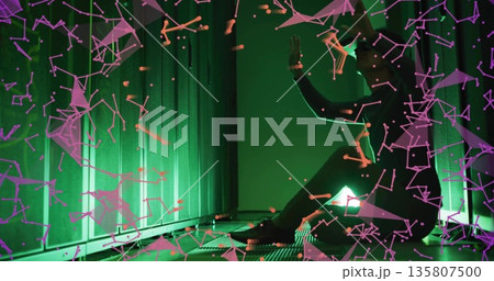 Korean man kneeling, analyzing holographic network in LED server hall with grated floor, copy space 135807500
