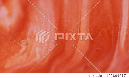 Acrylic fluid. Wet texture. Defocused orange color grain paint in water chemical flow spreading on abstract art creative background. 135809617