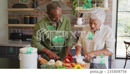 Chopping couple slicing vegetables at home kitchen island, with cutting board and chef's knives 135809756