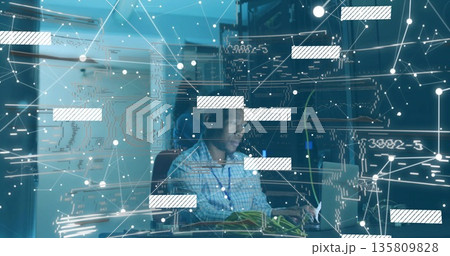 Connecting ethernet cables tech wearing checkered shirt monitoring network on laptop in server room 135809828