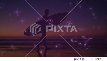 Walking silhouette surfer carrying surfboard on wet sand shore at dusk, with glowing constellations Walking silhouette surfer carrying surfboard on wet sand shore at dusk, with glowing constellations 135809938