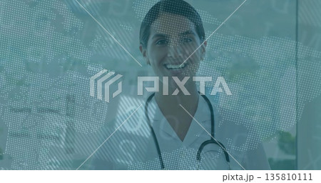 Smiling doctor standing at hospital glass panel, with stethoscope and digital map Smiling doctor standing at hospital glass panel, with stethoscope and digital map 135810111