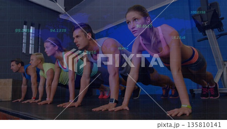 Holding plank position class participants on platform in gym studio, with wrist fitness trackers Holding plank position class participants on platform in gym studio, with wrist fitness trackers 135810141