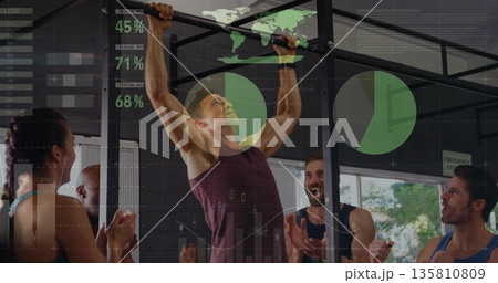Performing pull-up man in burgundy sleeveless top climbing rig at gym with graphics overlay 135810809