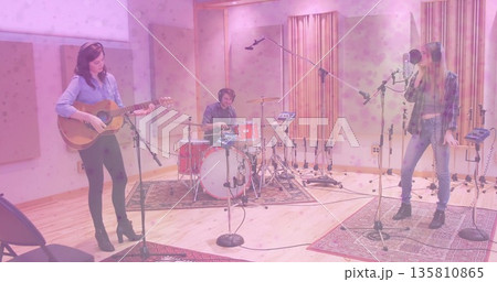 Performing music trio recording in sound studio, with acoustic guitar, drum kit and microphone Performing music trio recording in sound studio, with acoustic guitar, drum kit and microphone 135810865