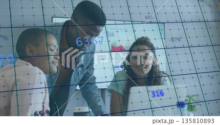 Collaborating team analyzing data in meeting room with laptop, coffee cup, plant, charts on screen Collaborating team analyzing data in meeting room with laptop, coffee cup, plant, charts on screen 135810893