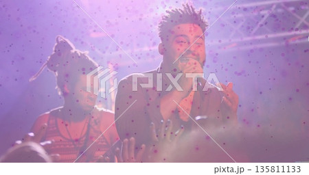 Singing African American singer holding microphone on concert stage, with electric guitar and haze Singing African American singer holding microphone on concert stage, with electric guitar and haze 135811133