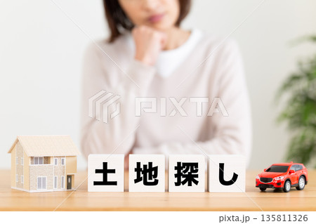 土地探しのブロックと悩むミドル女性 135811326