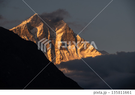 Beautiful view of Mt.Lhotse (8,516 m) at sunset seen from Khumjung village, Nepal. Mt.Lhotse the fourth highest mountain in the world at 8,516 metres on the way to Everest base camp in Nepal. 135811661