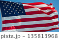American flag waving proudly against clear blue sky 135813968