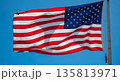 American flag waving proudly against clear blue sky 135813971