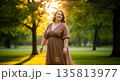 Happy young woman enjoying nature in serene park at sunset 135813977