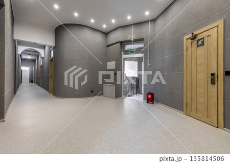 Modern hostel hallway with grey textured walls and curved architecture Modern hostel hallway with grey textured walls and curved architecture 135814506