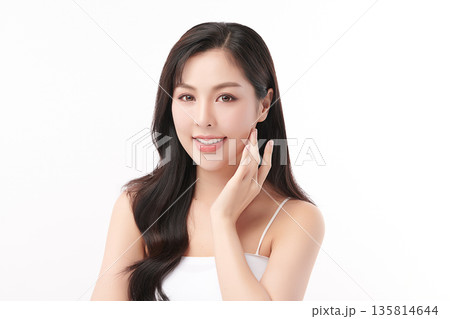 A beautiful young Asian woman with clean, fresh skin against a white background. Skincare, facial treatment, cosmetology, beauty, and spa. An elegant portrait of an Asian woman. A beautiful young Asian woman with clean, fresh skin against a white background. Skincare, facial treatment, cosmetology, beauty, and spa. An elegant portrait of an Asian woman. 135814644